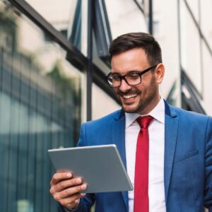 Director holding an ipad, using Stellar's board management platform