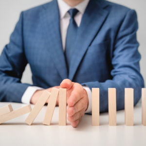 domino blocks man in suit stopping the fall