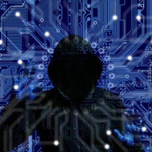 SIlhouette of hooded person accessing code