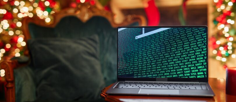 Laptop with code with christmas lights